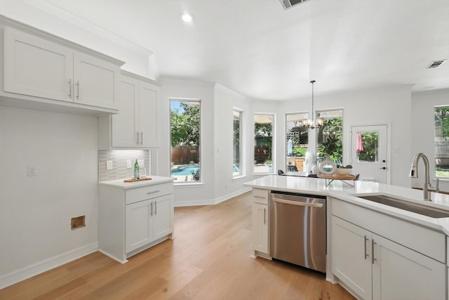 kitchen with dishwasher, a sink, healthy amount of natural light, light countertops, and recessed lighting