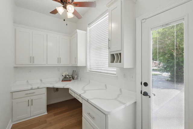 laundry room featuring wood finished floors, ceiling fan, and a desk
