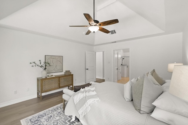 bedroom featuring wood finished floors, baseboards, high vaulted ceiling, and ceiling fan