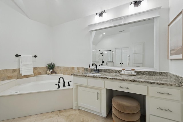 bathroom with a garden tub, vanity, a shower stall, tile patterned floors, and lofted ceiling
