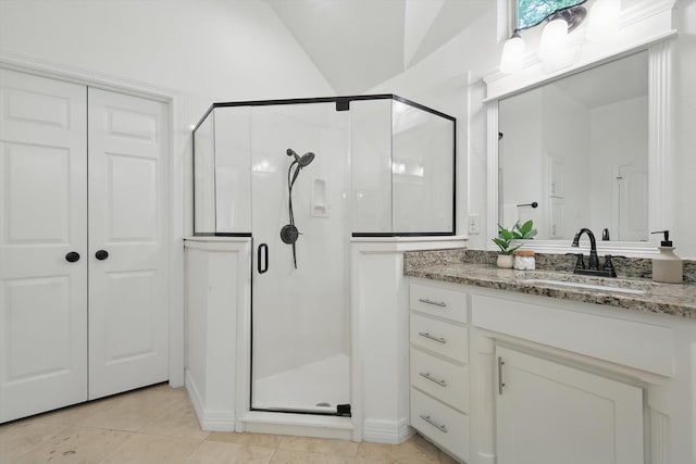 full bath featuring a stall shower, vanity, tile patterned flooring, and lofted ceiling