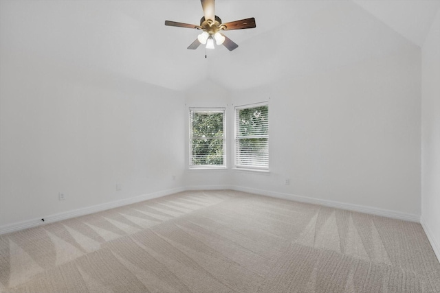 unfurnished room with light carpet, baseboards, vaulted ceiling, and ceiling fan