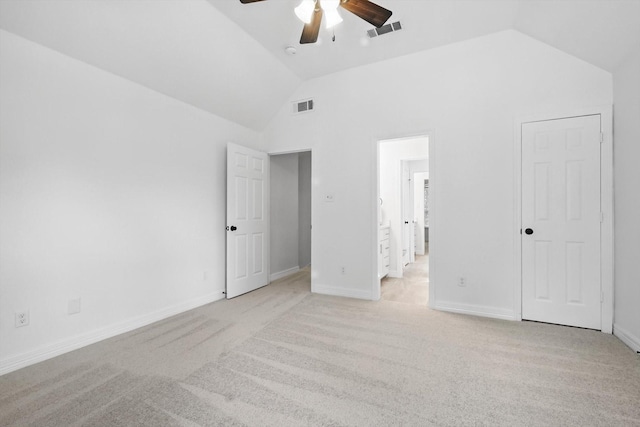 unfurnished bedroom featuring vaulted ceiling, light colored carpet, baseboards, and a ceiling fan