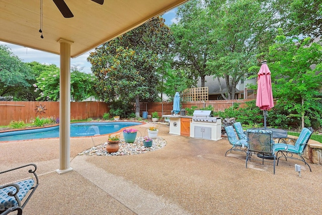 view of swimming pool with a fenced backyard, ceiling fan, and a patio area