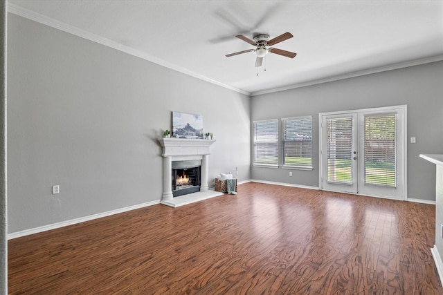 817 Countryside Dr, Aubrey, TX 76227 - unfurnished living room with a warm lit fireplace, ceiling fan, wood finished floors, crown molding, and baseboards