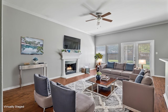 817 Countryside Dr, Aubrey, TX 76227 - living room featuring ceiling fan, a lit fireplace, wood finished floors, ornamental molding, and baseboards