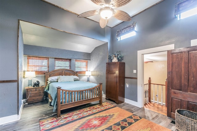 bedroom with baseboards, a ceiling fan, and wood finished floors