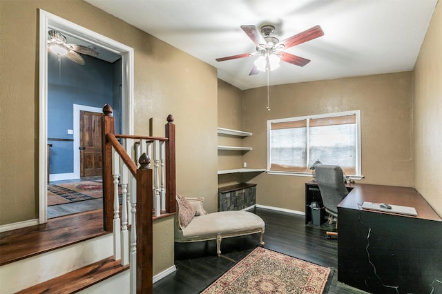 home office with baseboards, ceiling fan, a textured wall, and wood finished floors