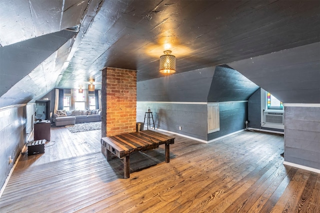 bonus room with baseboards, cooling unit, vaulted ceiling, and hardwood / wood-style flooring