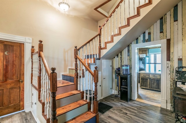stairs featuring baseboards and wood finished floors