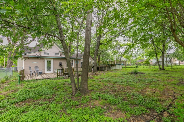 view of yard featuring fence and a deck