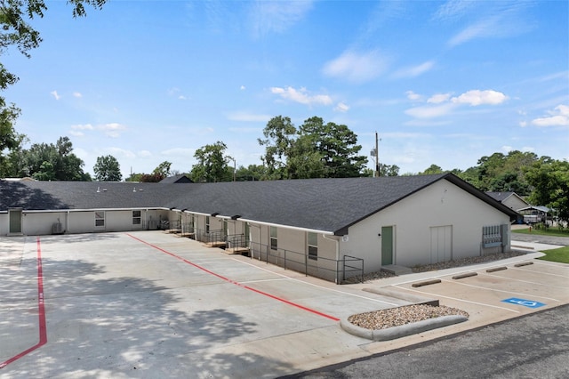 view of property featuring uncovered parking