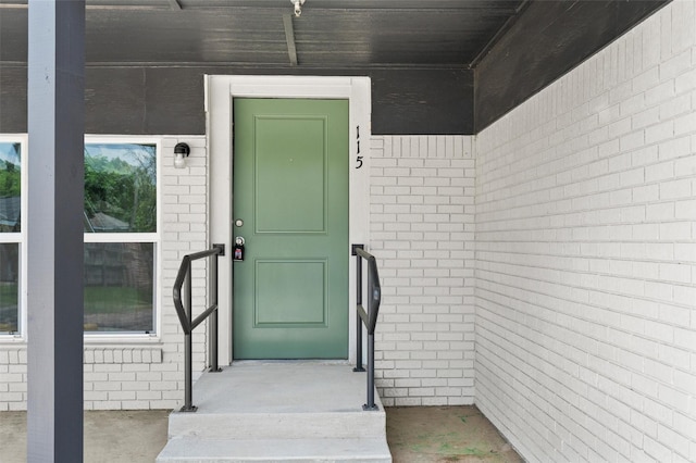 entrance to property with brick siding