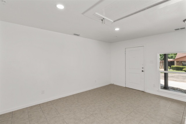 spare room with recessed lighting, visible vents, and attic access