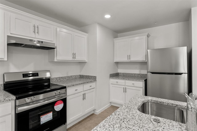 kitchen with a sink, appliances with stainless steel finishes, under cabinet range hood, and white cabinetry