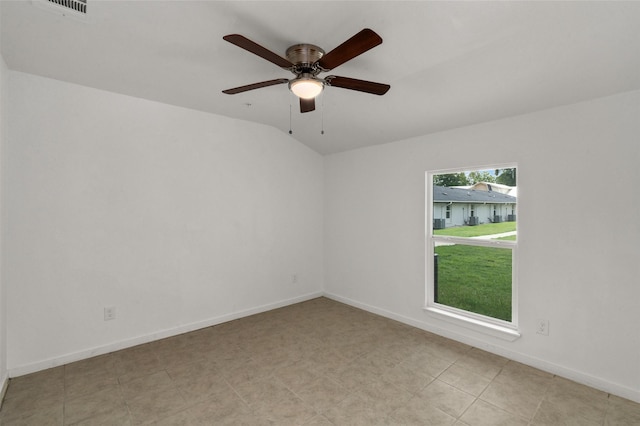 unfurnished room with ceiling fan, visible vents, baseboards, and lofted ceiling