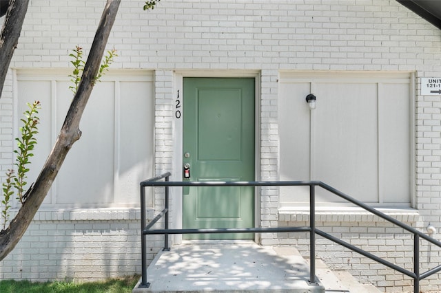 entrance to property with brick siding