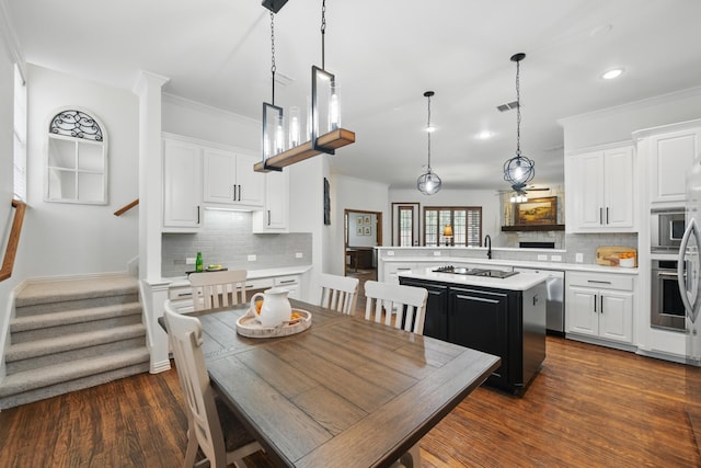 kitchen featuring light countertops, appliances with stainless steel finishes, decorative backsplash, and visible vents