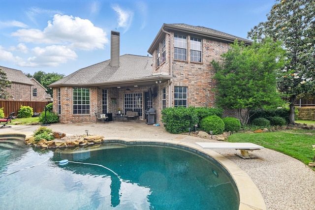 view of pool with fence, a fenced in pool, a patio area, and area for grilling
