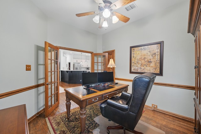 office featuring a ceiling fan, french doors, visible vents, wood finished floors, and baseboards