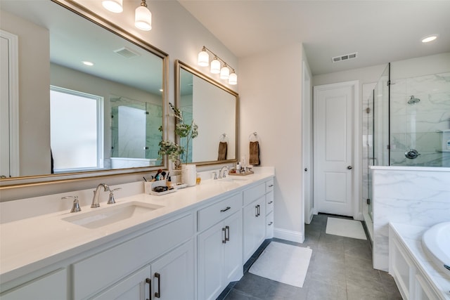 bathroom featuring double vanity, visible vents, a shower stall, and a sink
