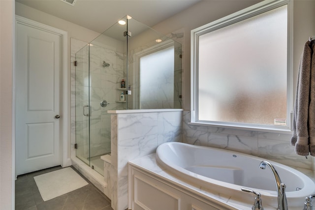full bath featuring tile patterned flooring, a bath, and a stall shower