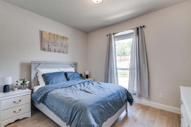 bedroom featuring baseboards and light wood-style flooring