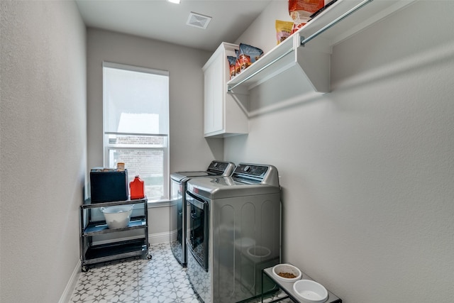 washroom featuring visible vents, baseboards, light floors, cabinet space, and independent washer and dryer