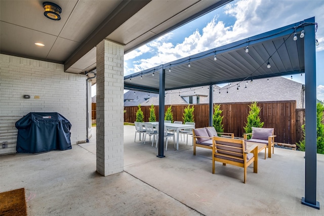 view of patio / terrace with outdoor dining area, a fenced backyard, and a grill