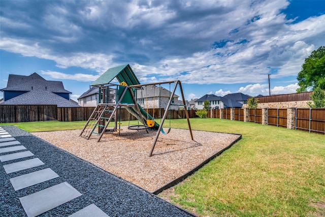 view of jungle gym featuring a lawn, a residential view, and a fenced backyard