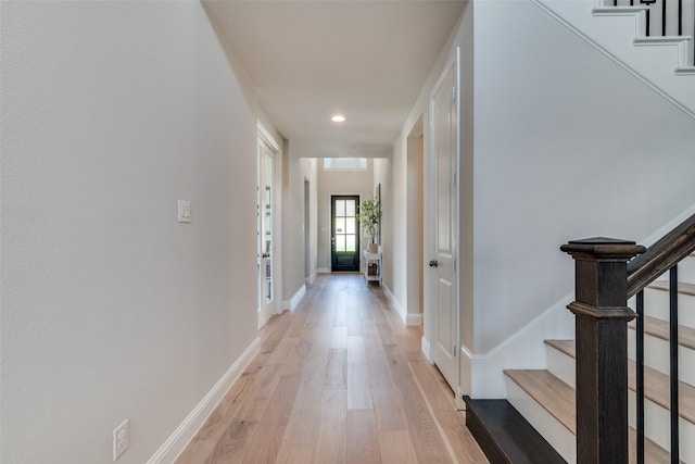 hall featuring stairway, recessed lighting, baseboards, and light wood-type flooring