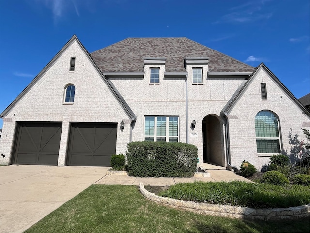 7040 Cross Point Ln, Little Elm, TX 76227 - view of front of property with concrete driveway, a shingled roof, brick siding, and an attached garage