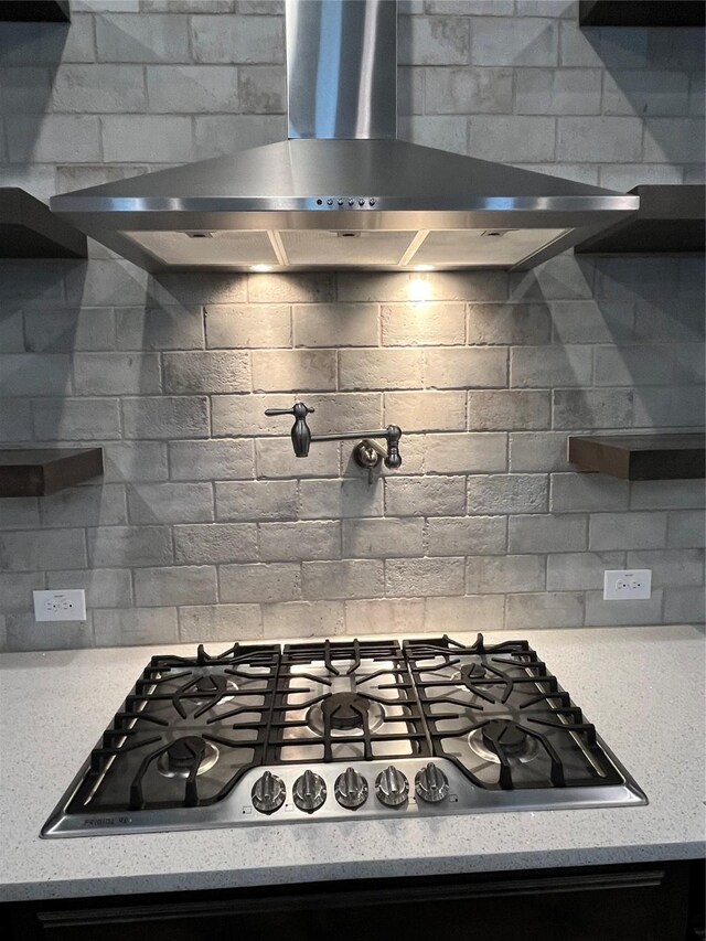 7040 Cross Point Ln, Little Elm, TX 76227 - kitchen featuring wall chimney exhaust hood, stainless steel gas stovetop, tasteful backsplash, and open shelves