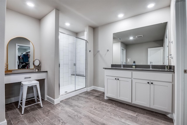 1349 Rolling Meadows Dr, Cedar Hill, TX 75104 - bathroom featuring a spacious closet, baseboards, a shower stall, and wood finished floors