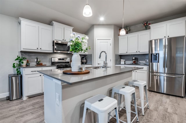 1349 Rolling Meadows Dr, Cedar Hill, TX 75104 - kitchen featuring a sink, a kitchen breakfast bar, decorative backsplash, stainless steel appliances, and white cabinets