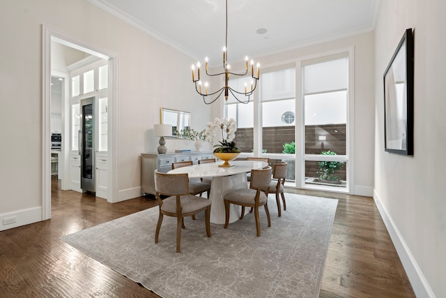 dining area featuring baseboards, ornamental molding, a chandelier, and dark wood-type flooring