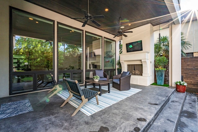 view of patio / terrace featuring a ceiling fan and an outdoor fireplace
