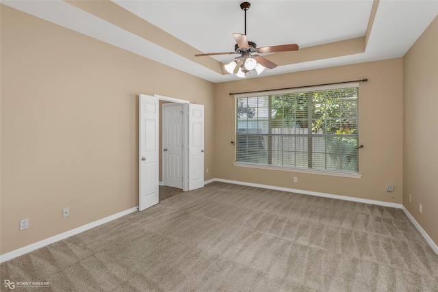 174 Hallette Dr, Shreveport, LA 71115 - empty room featuring a tray ceiling, ceiling fan, carpet floors, and baseboards