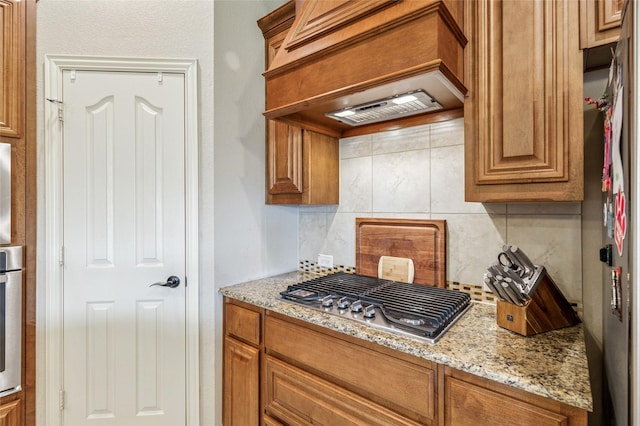 2828 Mariposa Dr, Grand Prairie, TX 75054 - kitchen with appliances with stainless steel finishes, a sink, brown cabinets, arched walkways, and recessed lighting
