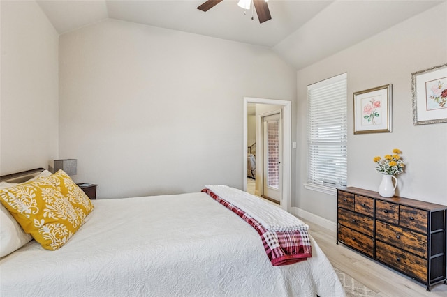 2828 Mariposa Dr, Grand Prairie, TX 75054 - bedroom featuring lofted ceiling, light wood-style floors, a barn door, connected bathroom, and ceiling fan
