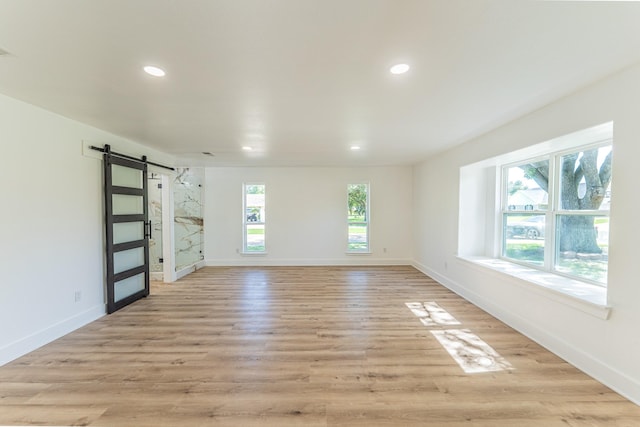 229 W Oaks Cir, Sulphur Springs, TX 75482 - spare room featuring a barn door, recessed lighting, baseboards, and light wood-type flooring