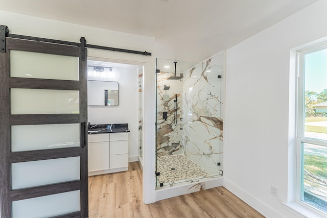 229 W Oaks Cir, Sulphur Springs, TX 75482 - full bath with wood finished floors, a marble finish shower, vanity, and baseboards