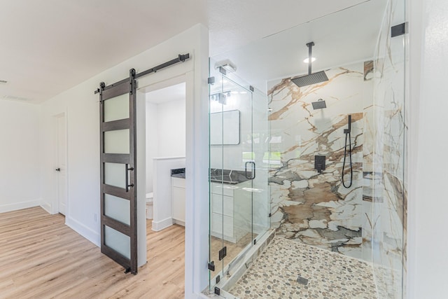 229 W Oaks Cir, Sulphur Springs, TX 75482 - full bath with a marble finish shower, wood finished floors, toilet, and baseboards