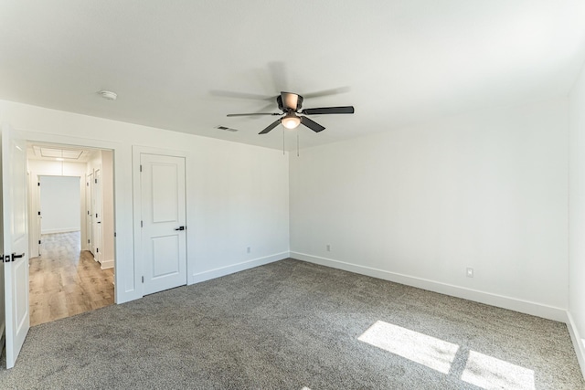 229 W Oaks Cir, Sulphur Springs, TX 75482 - carpeted empty room featuring attic access, a ceiling fan, and baseboards