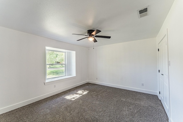 229 W Oaks Cir, Sulphur Springs, TX 75482 - empty room featuring ceiling fan, dark colored carpet, and baseboards