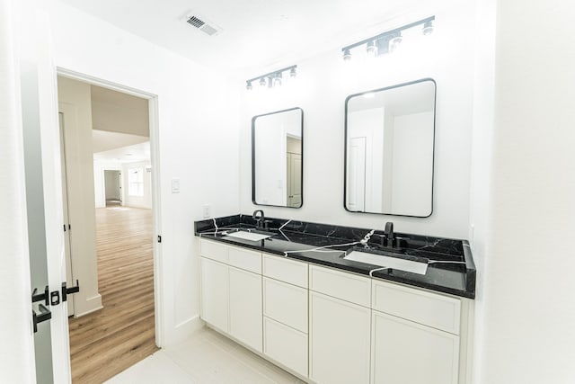 229 W Oaks Cir, Sulphur Springs, TX 75482 - bathroom with double vanity, baseboards, and tile patterned flooring