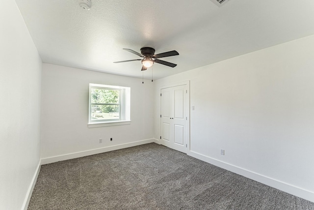 229 W Oaks Cir, Sulphur Springs, TX 75482 - unfurnished room featuring dark colored carpet, a ceiling fan, baseboards, and a smoke detector