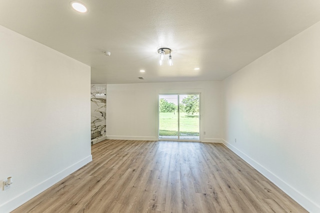 229 W Oaks Cir, Sulphur Springs, TX 75482 - unfurnished living room featuring light wood-style flooring, baseboards, and recessed lighting