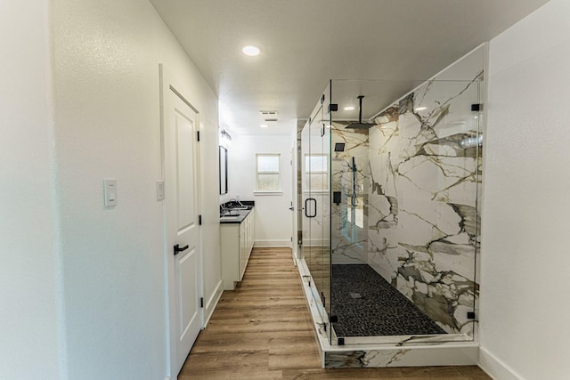 229 W Oaks Cir, Sulphur Springs, TX 75482 - bathroom featuring a marble finish shower, vanity, wood finished floors, baseboards, and recessed lighting