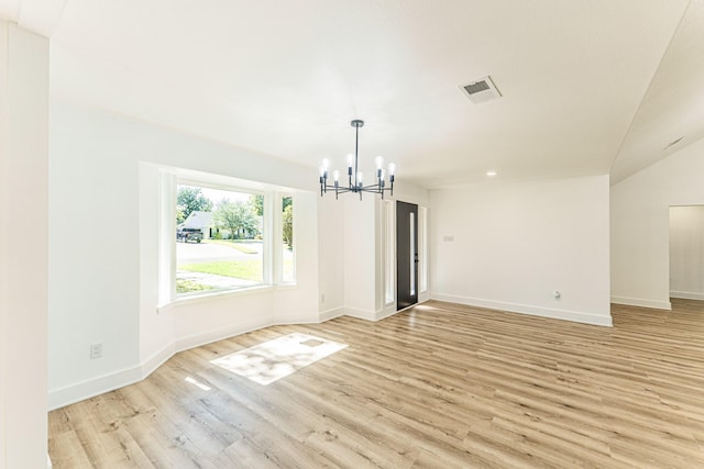 229 W Oaks Cir, Sulphur Springs, TX 75482 - spare room with a chandelier, light wood-style floors, and baseboards